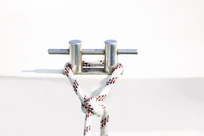 Close-up of snow on pole against sky