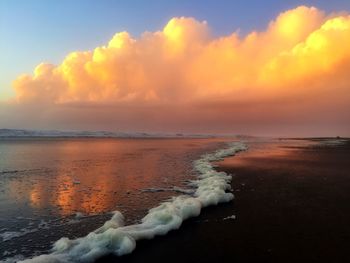 Scenic view of sea against cloudy sky