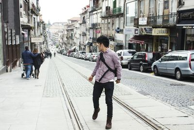 Rear view of woman walking on street in city