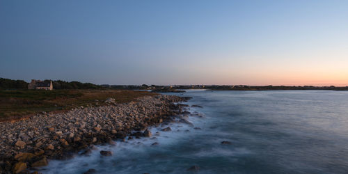 Scenic view of sea against clear sky during sunset