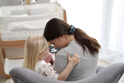 Mother embracing with daughter