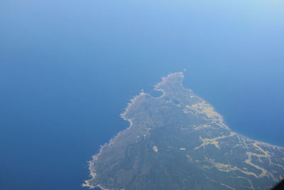 Scenic view of snowcapped mountains against clear blue sky