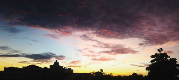 Silhouette of building against dramatic sky