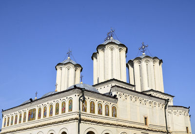 Low angle view of building against clear blue sky