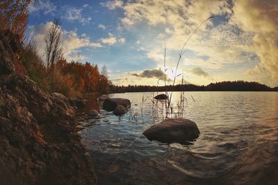 Scenic view of lake against cloudy sky