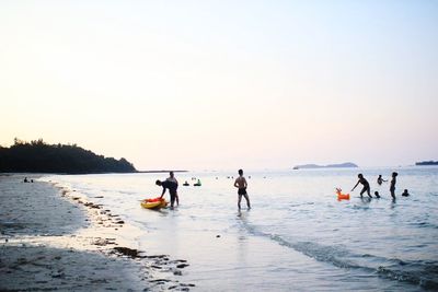 People on beach at sunset