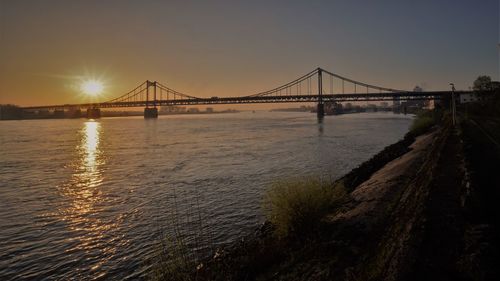 View of suspension bridge at sunset