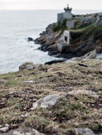 Close-up of rocks on beach against sky