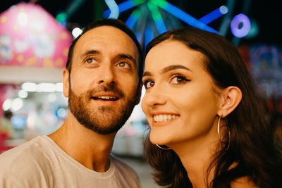 Contemplating couple standing at amusement park