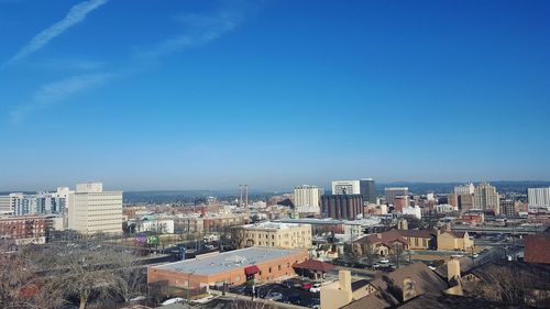 High angle view of townscape against blue sky