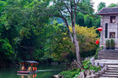 Scenic view of lake amidst trees and buildings