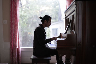 Young man playing piano