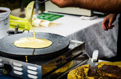 Close-up of person preparing food at kitchen