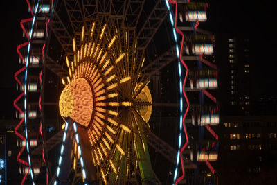 Illuminated ferris wheel at night