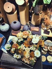 High angle view of dry flowers in tray by decoration on table