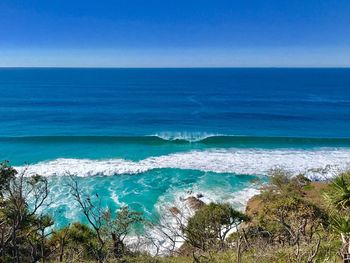 Scenic view of sea against clear blue sky