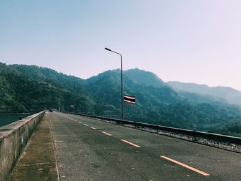 Road by mountain against clear sky