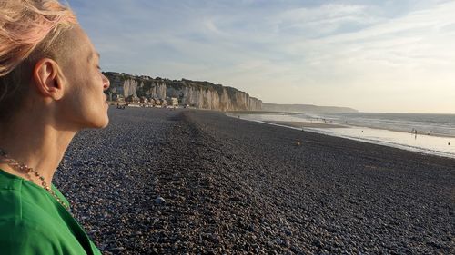 Woman on beach against sky