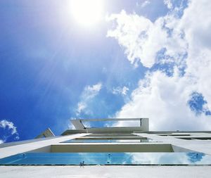 Low angle view of windmill against blue sky