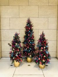 Christmas tree on floor against wall