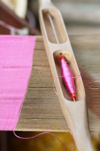 Close-up of needle with pink thread