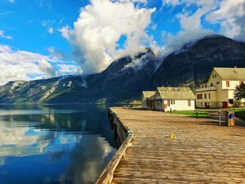 Panoramic view of lake by buildings against sky - eidfjord 