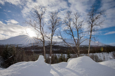 Scenic view of snow covered mountains against sky