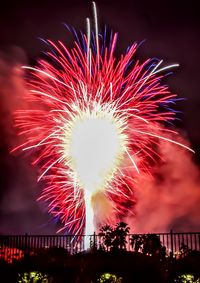 Low angle view of firework display at night