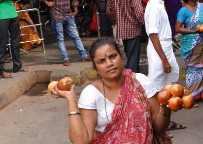 Woman holding fruits in market