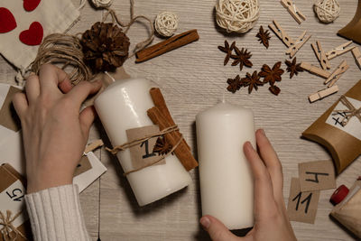 Cropped hand of woman holding christmas tree