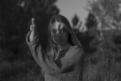 Portrait of a young woman wearing mask outdoors