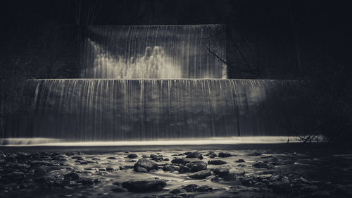 Scenic view of waterfall against trees