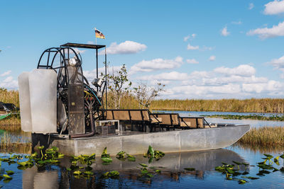 Airboat in lake at everglades national park against blue sky