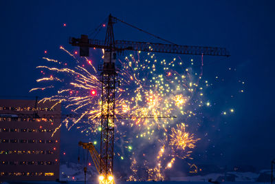 Low angle view of firework display at night