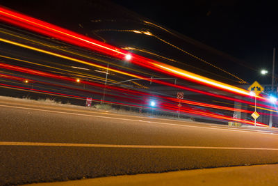 Light trails on road in city at night