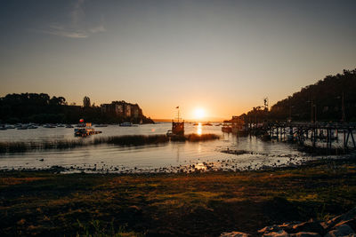 Scenic view of river against sky during sunset