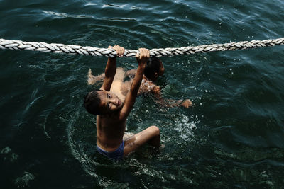 High angle view of man swimming in sea