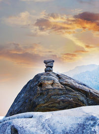 Scenic view of rock against sky during sunset