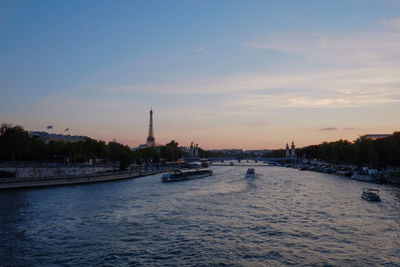 View of city at waterfront during sunset