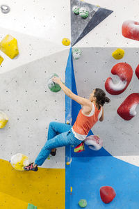 Woman climbing on wall