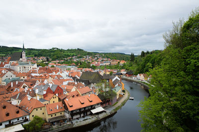 High angle view of river amidst buildings against sky