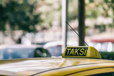 Close-up of sign on taxi in city