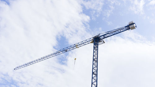 Low angle view of crane against sky