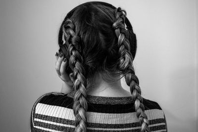 Rear view of woman against wall