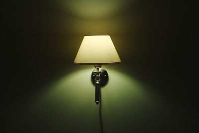 Close-up of illuminated lamp on wall