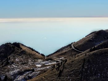 Scenic view of sea and mountains against sky