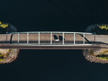 Bridge over river against sky at night