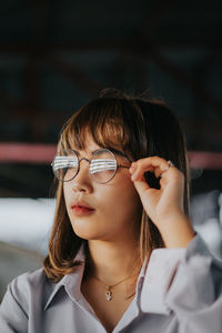 Portrait of young woman looking away