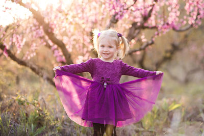 Portrait of cute girl standing at park