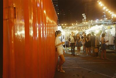 People in illuminated city at night